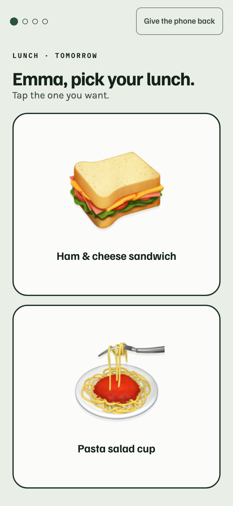 Kid’s pick: Emma asked to pick one part of tomorrow’s box, two foods stacked one above the other, each filling half the screen with a big picture and its name, a row of dots showing how many parts are left, and a Give the phone back button at the top.